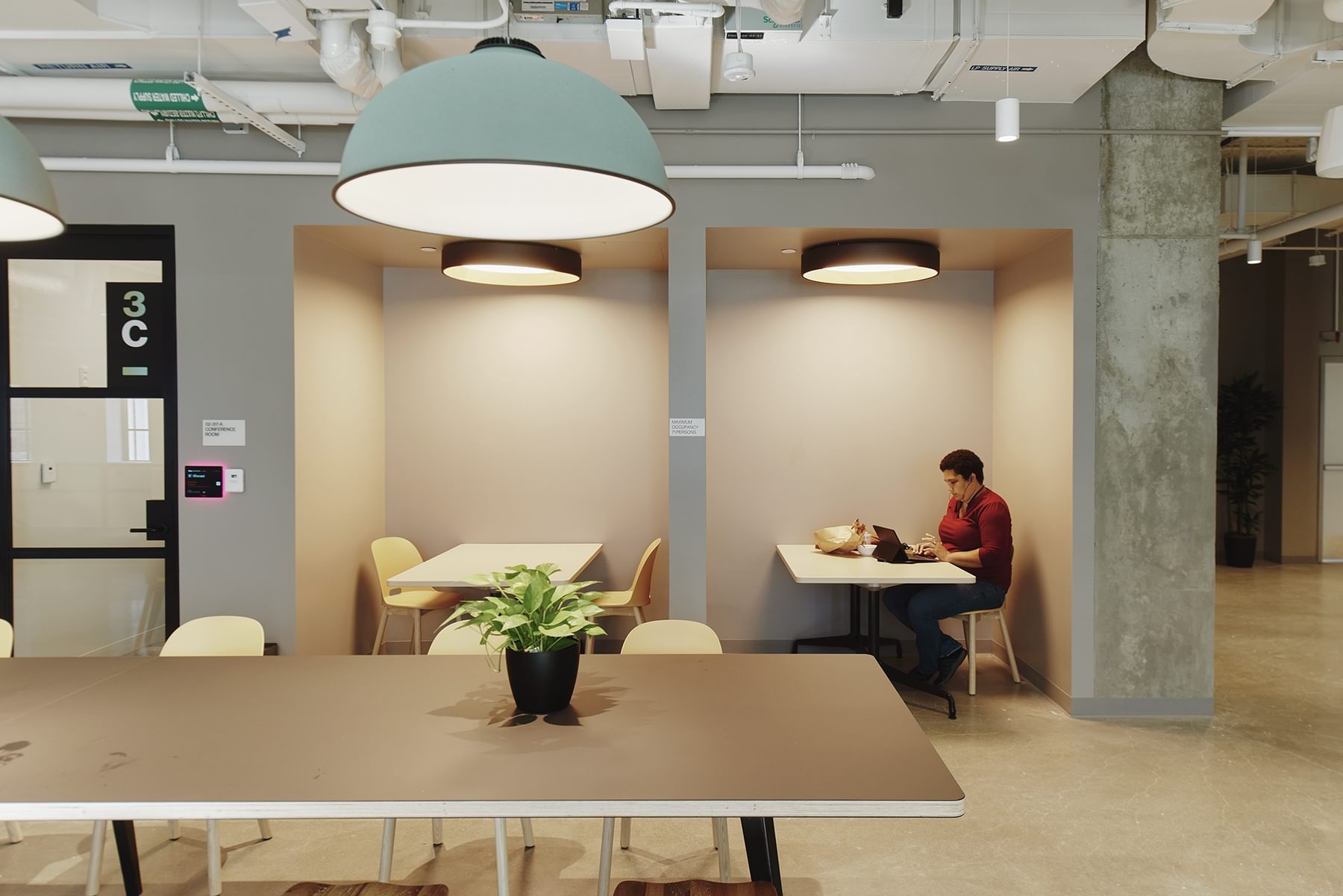 A man works alone in the common shared space at The Engine.