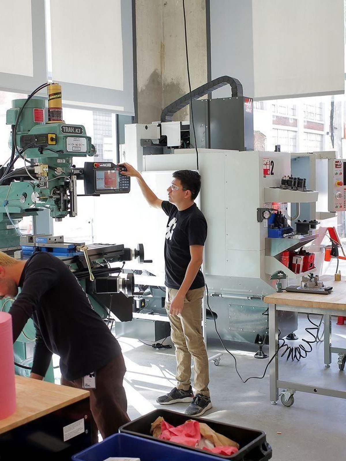 Engineers work with rapid prototyping tools in the fabrication space at The Engine.