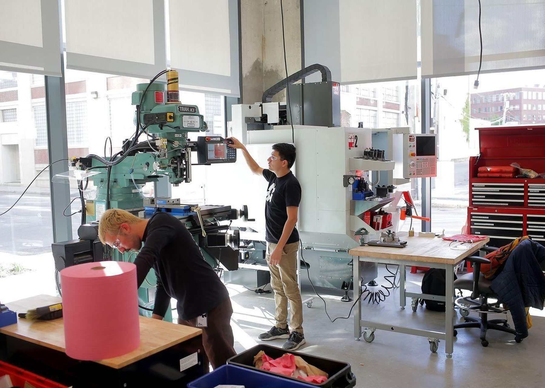 Engineers work with rapid prototyping tools in the fabrication space at The Engine.
