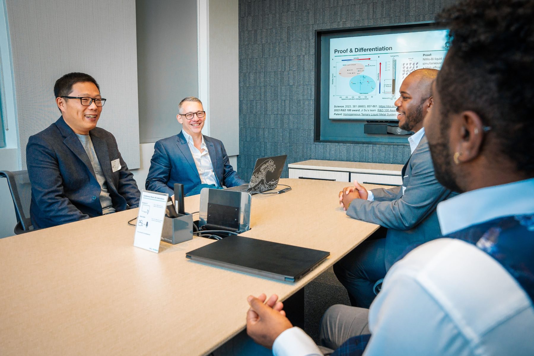 A group of four men sit around a table during Blueprint.