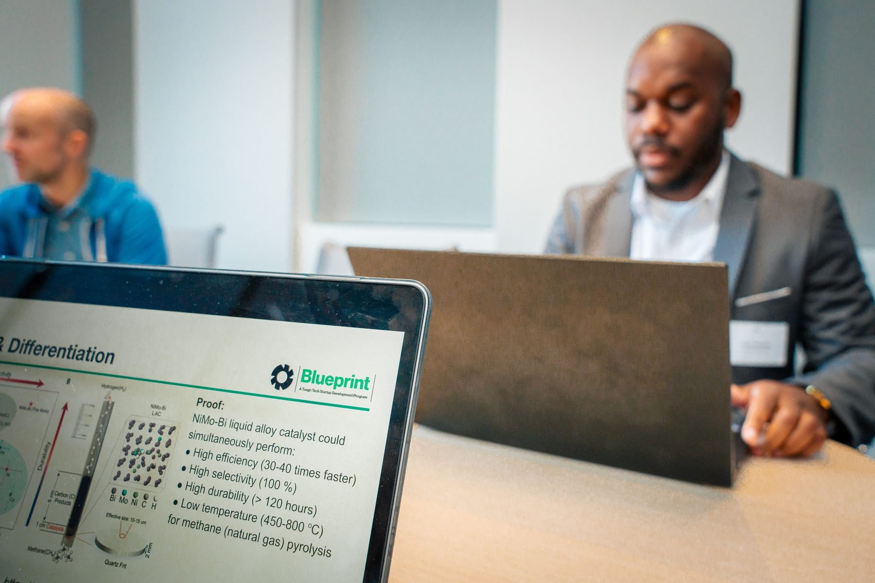 A Blueprint particpant sits in front of an open laptop.