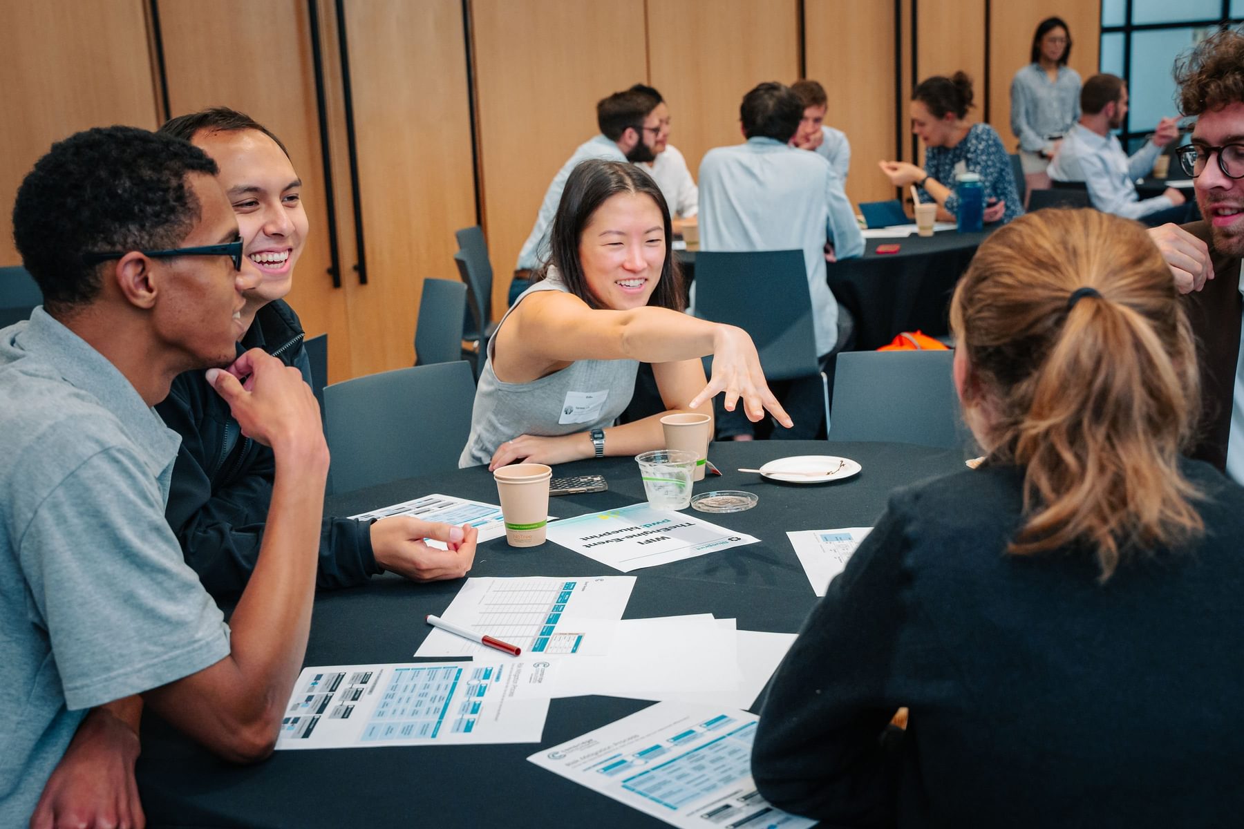 Blueprint participants have an engaging discussion around a table in The Engine's event space.