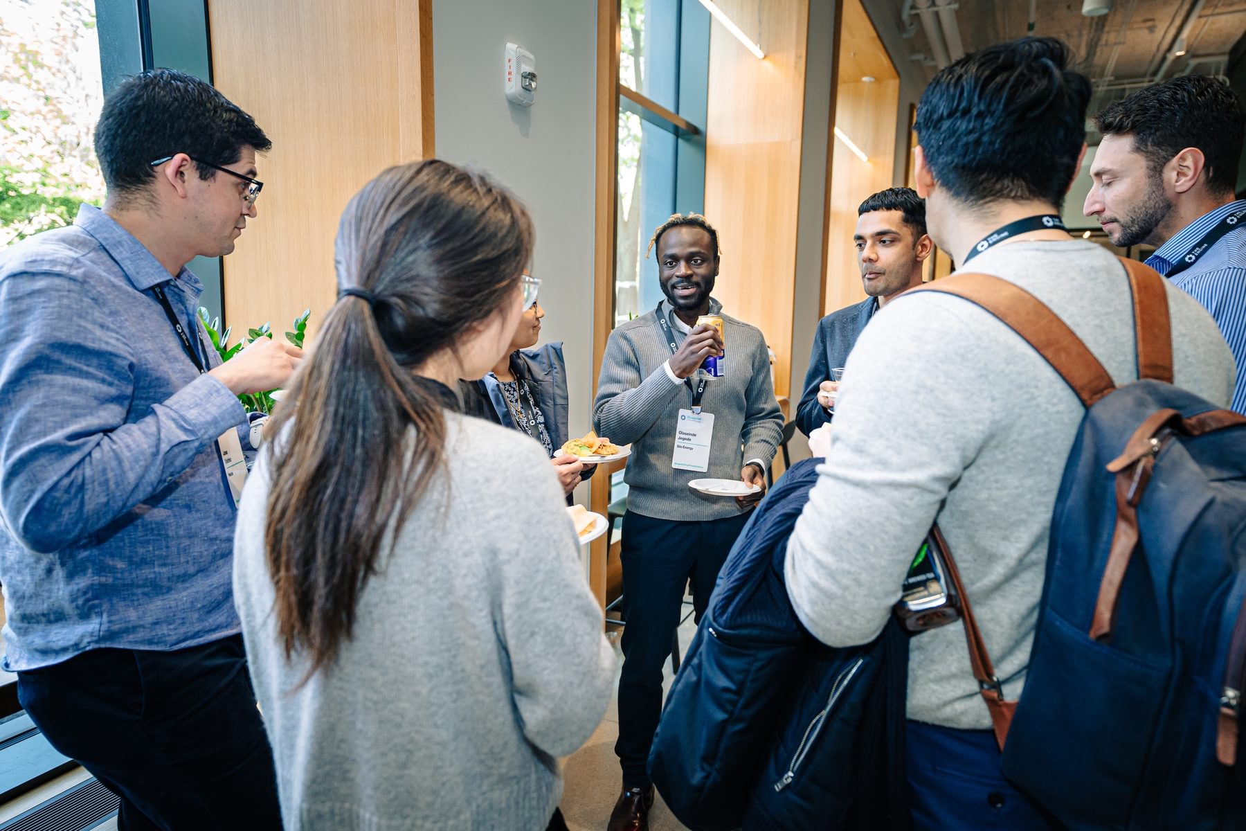 A group of people congregate in a circle during a networking session at the Blueprint Showcase.