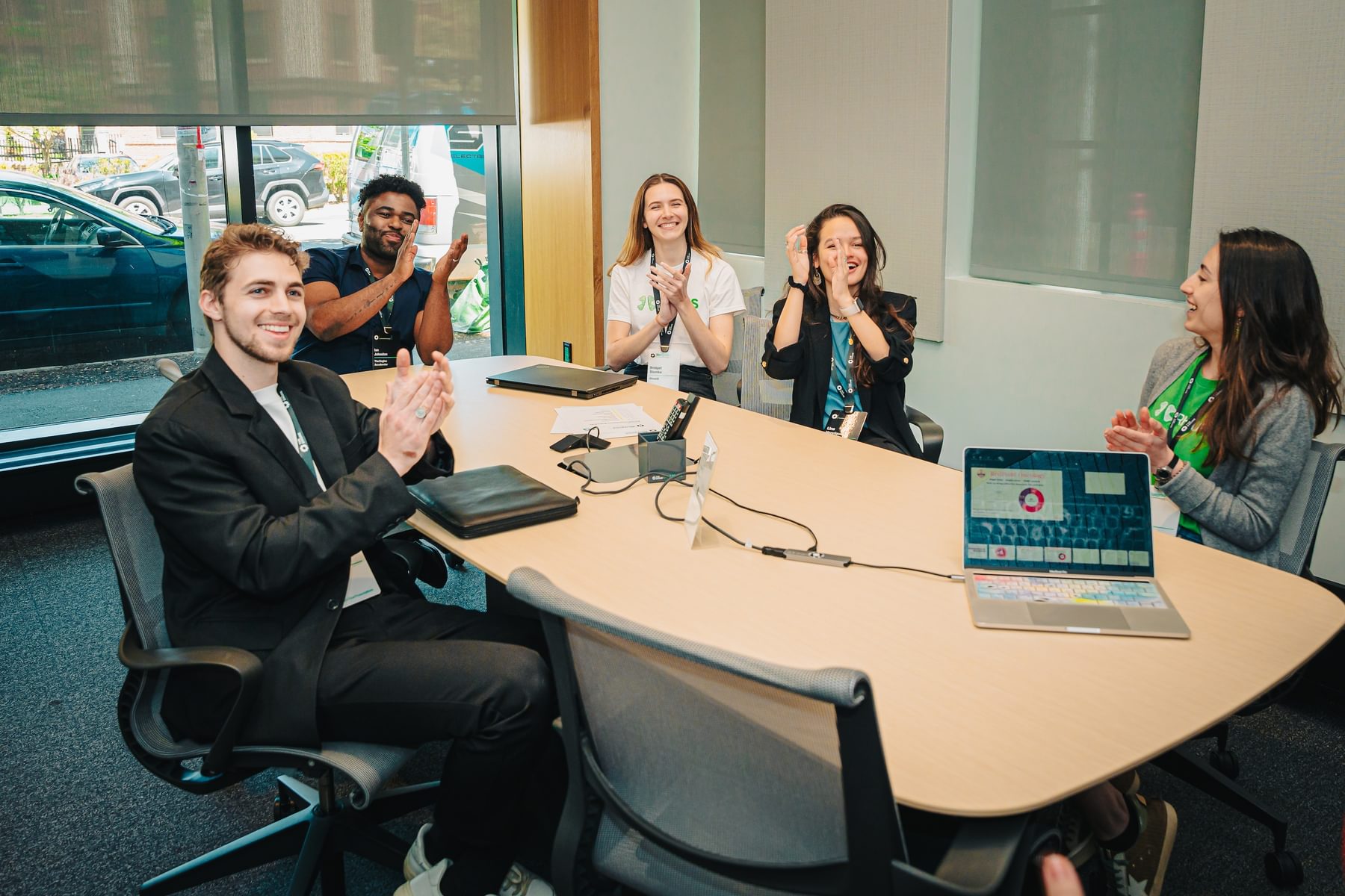 A table of people applaud a presentation during the Blueprint Showcase.