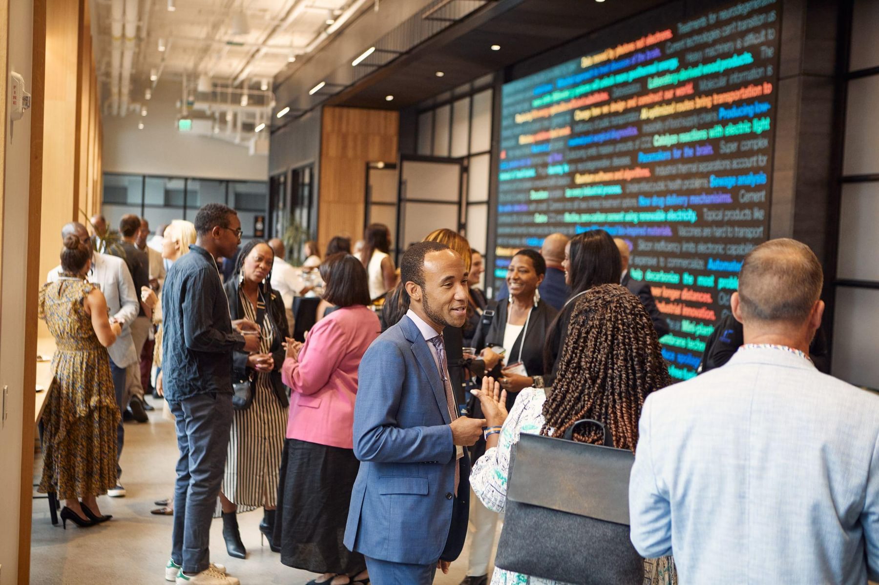 Visitors talk amongst themselves at a networking event in The Engine's event space.