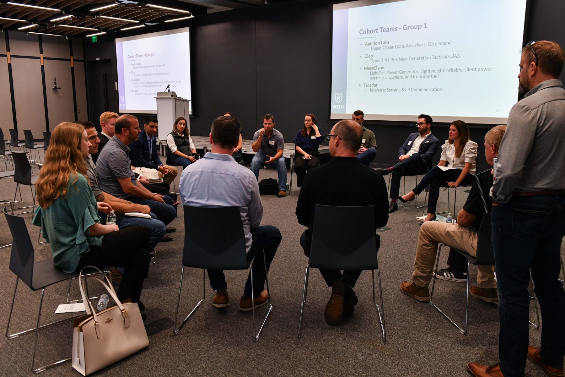 Blueprint participants sit on chairs in a circle in The Engine's event space.