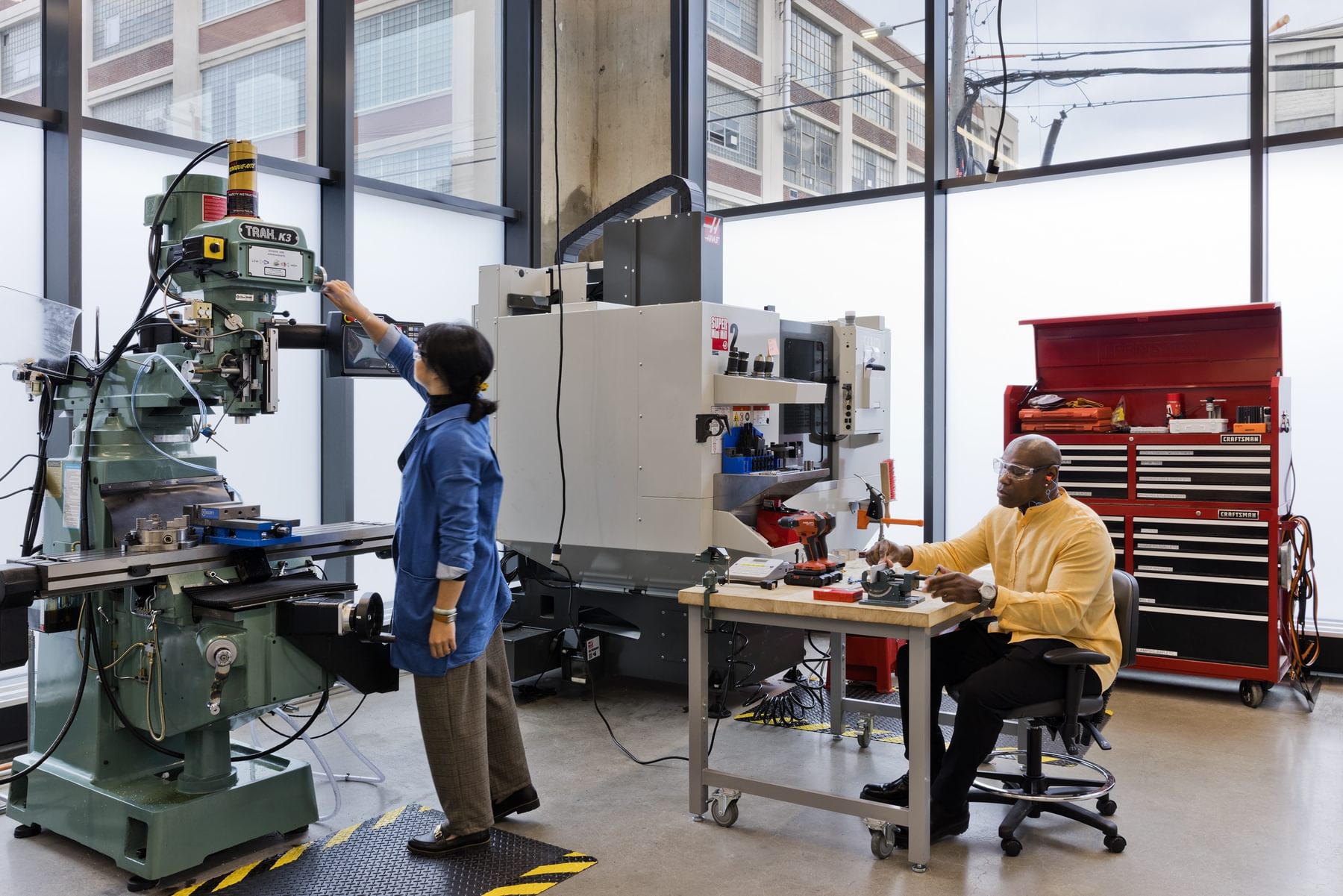 Engineers work with rapid prototyping tools in The Engine's machine shop.