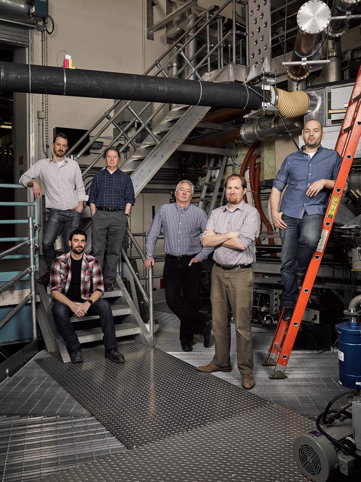 The founders of fusion energy company Commonwealth Fusion Systems pose in their lab.