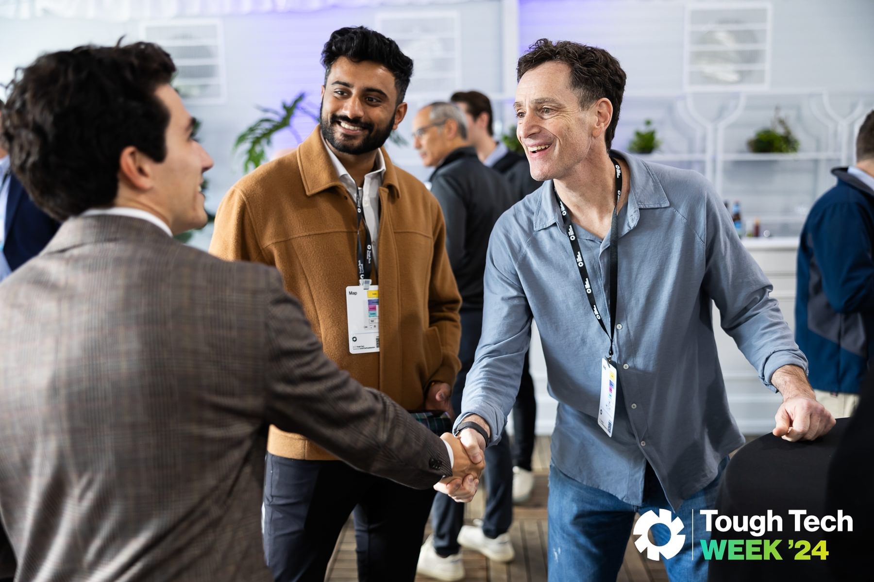 Investors and founders shake hands at The Engine's annual Tough Tech Week event.