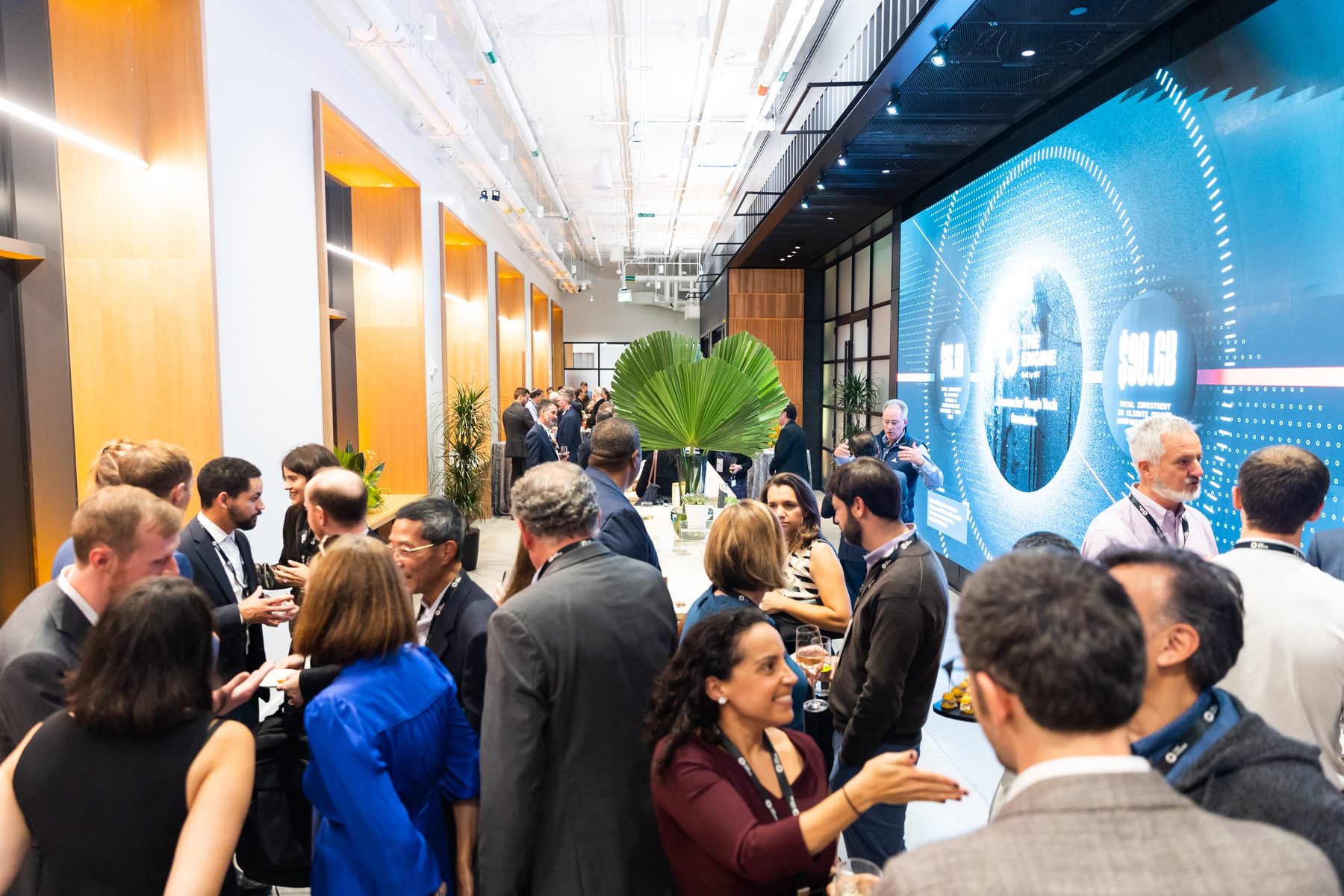 People congregate in The Engine's event space for the Tough Tech dinner.