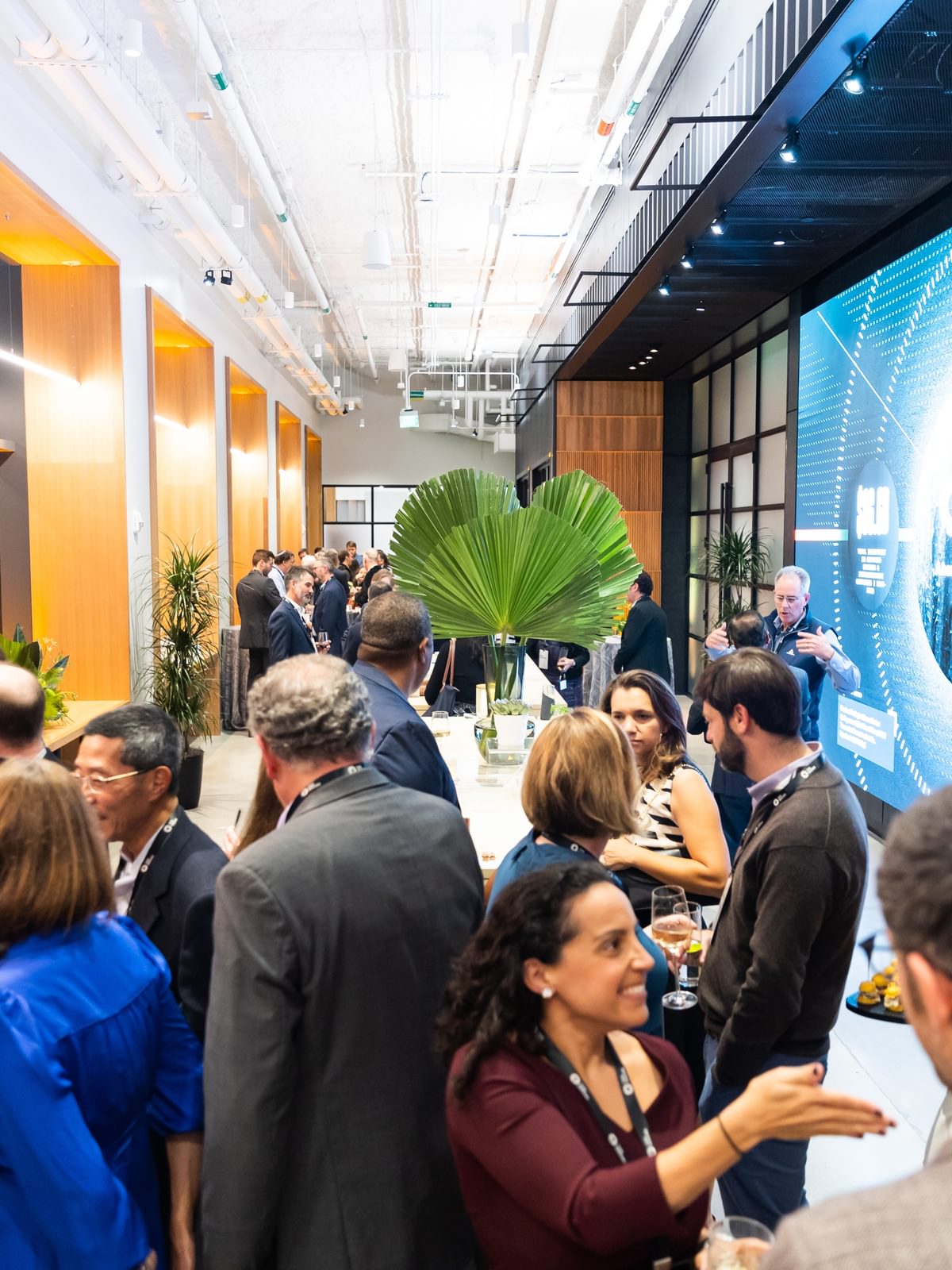 People congregate in The Engine's event space for the Tough Tech dinner.